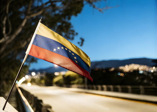 Fototapeta Close-up venezuera Flag Waving in the Wind. Evening background, In the capital of venezuera, city lights and road