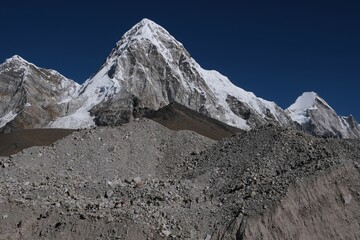Mountain scenery on trail to Gorakshep and Everest Base Camp. A lot of people on trail. Pumori mount in background. Everest Base Camp, Sagarmatha National Park, Khumbu valley, Himalayas