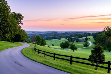 Naklejka premium Scenic sunrise over rolling hills, winding road.