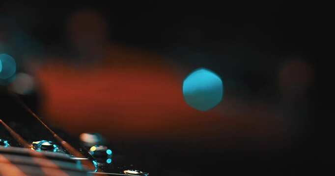 Close-Up of an Electric Guitar. Details of strings, frets, and the body shine under moody lighting. Music, creativity, and rock culture.