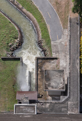 Bird's eye view of Drainage Khun Dan Prakan Chon Dam (Khlong Tha Dan Dam) reservoir on hill with...