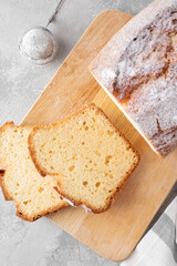 Delicious vanilla pound cake served with fresh berries and whipped cream on a gray concrete background. Selective focus, copy space.