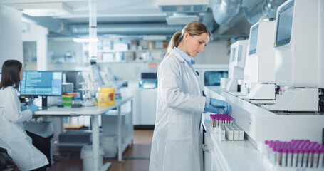 Portrait of a Female Lab Scientist at Work in a Modern Medical Research Facility. Bioengineer in a...