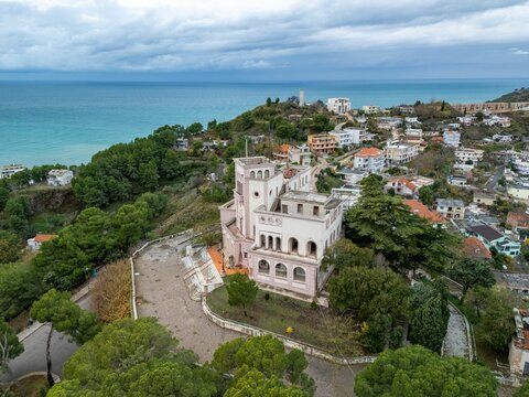 historic King Zog Villa surrounded by lush greenery and overlooking the Adriatic Sea in Albania.
