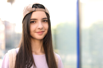 Portrait of teenage girl in stylish cap outdoors. Space for text