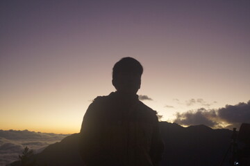 silhouette of a person in the mountains