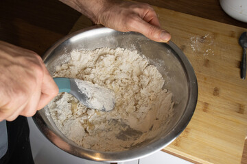 Man kneading dough. Cooking at home. Tasty and healthy food