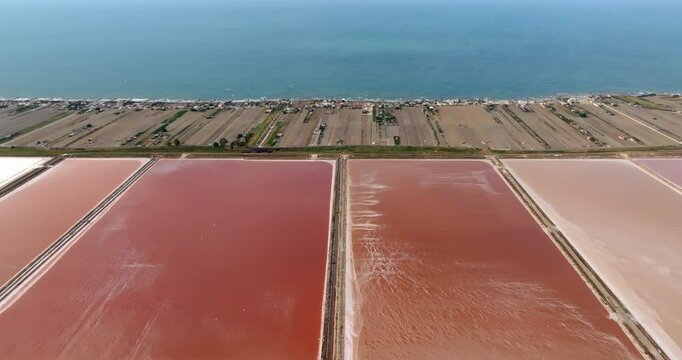 Aerial view of the Margherita di Savoia salt mines, in Puglia, Italy. They are the largest salt mines in Europe. In background is the Mediterranean Sea.