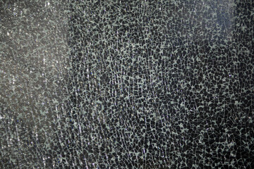 Small cracks on the glass. Broken window. Shards on the glass.