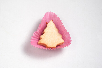 Christmas tree-shaped cookie in pink wrapper