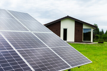 Fototapeta premium Solar panels at the private house. Technologies collecting electricity from sun rays. Eco-friendly power plant. Innovative sun panels. Alternative power supply system.