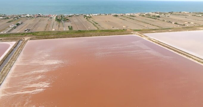 Aerial view of the Margherita di Savoia salt mines, in Puglia, Italy. They are the largest salt mines in Europe. In background is the Mediterranean Sea.