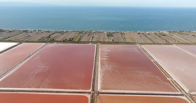 Aerial view of the Margherita di Savoia salt mines, in Puglia, Italy. They are the largest salt mines in Europe. In background is the Mediterranean Sea.