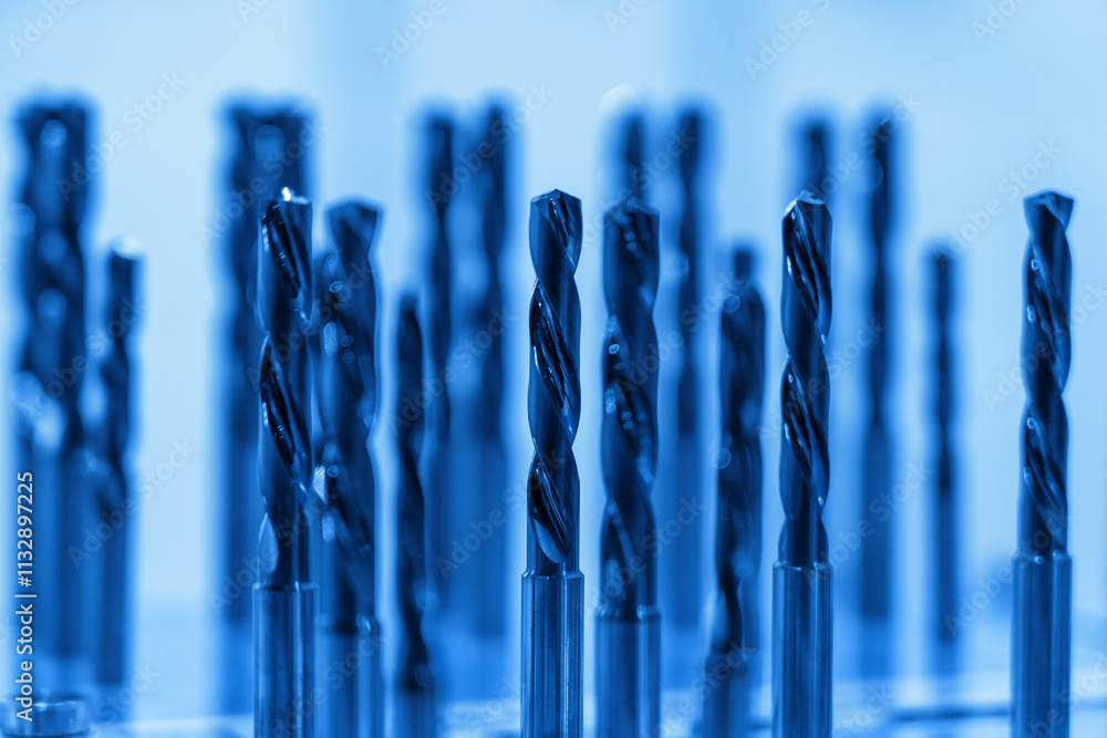 Poster a collection of precision drill bits stands prominently in the workshop, reflecting their sharp desi