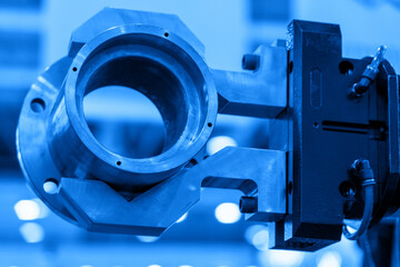 Details of an intricate machine part are featured prominently at an industrial event, highlighting...