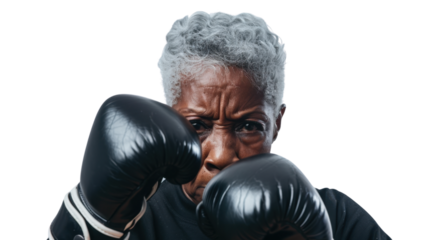 Professional african senior female boxer in gloves exercises punches on white background
