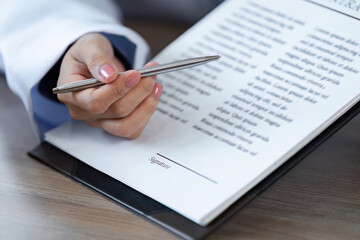 Doctor Advises Patient to Sign Important Medical Documents for Health and Treatment Authorization...