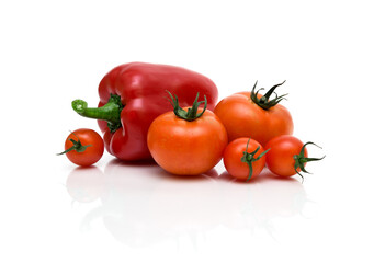 tomatoes and red peppers on a white background
