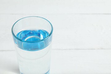Transparent glass with water on a wooden table. Drinking clear water in the morning for health