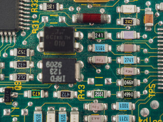 Close-up of microcircuits and components: chips, diodes and capacitors on a printed circuit board,...