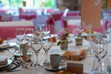 This beautifully set table showcases an exquisite arrangement of pink and white flowers, creating a stunning focal point, all ready for a memorable special event or celebration.