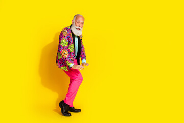 Fototapeta premium Full length photo of retired man enjoy disco have fun dance dressed stylish colorful pink fancy clothes isolated on yellow color background