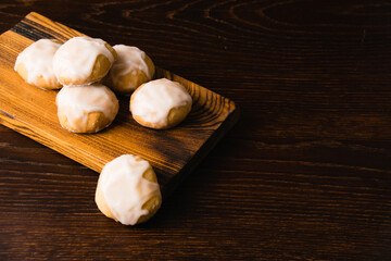 Homemade gingerbread cookies with honey and cinnamon with white sugar fondant, on a dark wooden...