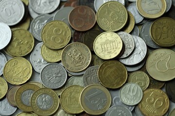 Big pile of different coins from various currencies and different countries around the world....