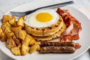 fried eggs on stack waffles   with home fries
