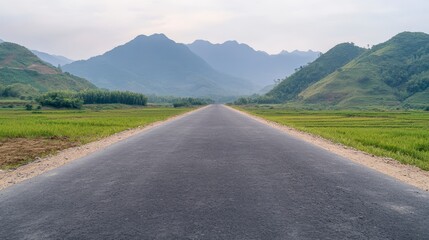 Fototapeta premium Scenic Asphalt Road Through Lush Green Rice Paddies and Mountains