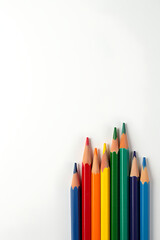 Fototapeta premium A group of colorful pencils sit on a blank piece of notebook paper emphasizing business, creativity, and educational concepts._00001_