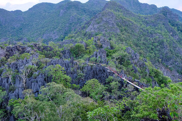 Hiking to the top of a limestone mountains in Laos and the stunning aerial view of the limestone...