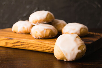 Homemade gingerbread cookies with honey and cinnamon with white sugar fondant, on a dark wooden...