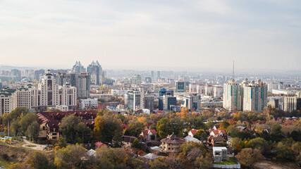 Fototapeta premium Aerial view of Almaty Kazakhstan mix of architectural styles, red roofs, cityscape and greenery.