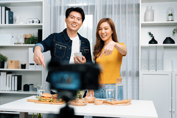 Chef influencers reading comment on phone for answer time on social media cooking show channel live...