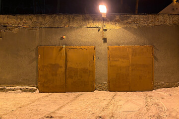 Garage door at night in the light of a lantern