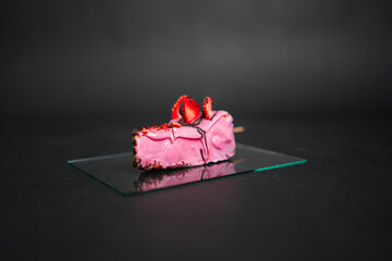 Close-Up of Strawberry Mousse Dessert on Glass Plate Against Dark Background