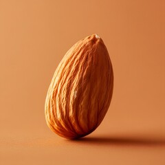 A single almond is displayed on a warm, neutral background, showcasing its textured surface and natural color, emphasizing its organic beauty.