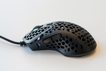 A gaming mouse with perforated shell design and adjustable DPI settings, placed on a white background.