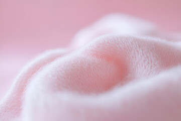 Fototapeta premium A soft, pink fabric draping gently, creating a serene and cozy atmosphere.