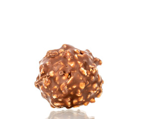 Chocolate candies with hazelnuts, close-up, isolated on white background.