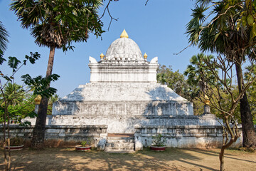 The That Pathum stupa at Wisunarat temple in Luang Prabang, the old capital of Laos, which is surrounded by trees .