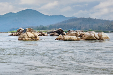 Rapids in the Mekong river, Luang Prabang, Laos, with the mountains are in the background.