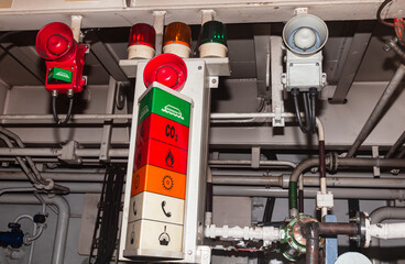 Ship's engine room alarm stand with various alarm options.