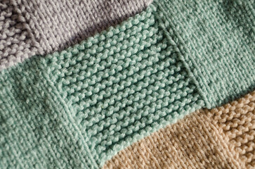 Knitting, handwork. Garter stitch pattern from wool yarn.