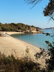 A breathtaking view of the Greek peninsula of Halkidiki, featuring the stunning regions of Sithonia, Kassandra, and Mount Athos. The photo captures the crystal-clear blue sea, golden sandy beaches