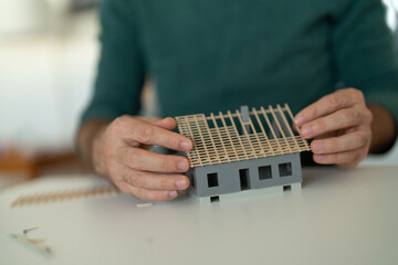 Man builds model house together