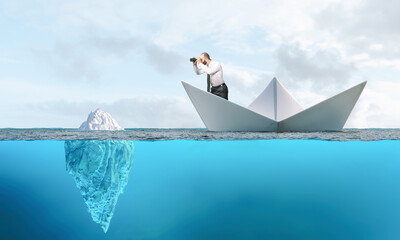 Businessman sailing in a paper boat