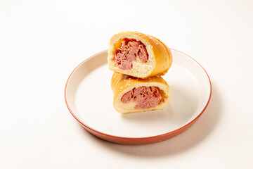Cachito of ham. bread of ham, over a white plate on white background