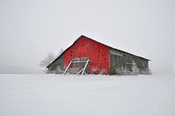 red barn in winter snow landscape